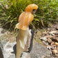 Orange calcite parrot on black tourmaline matrix